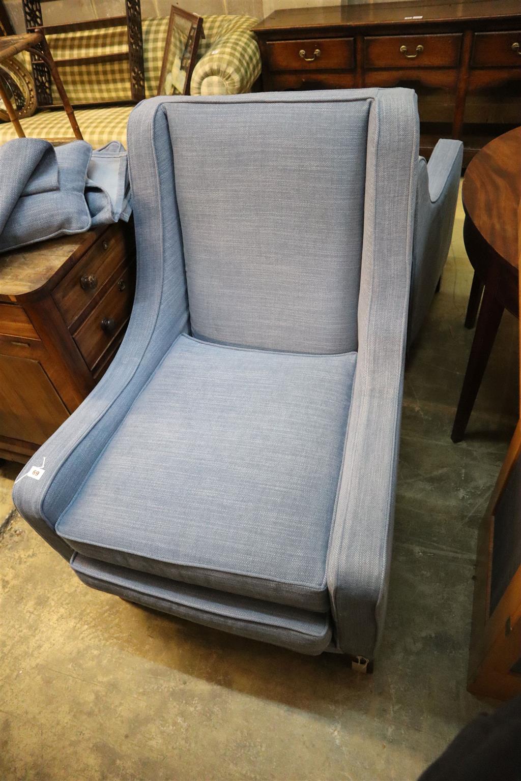 Two modern square frame armchairs with blue upholstery and a matching footstool